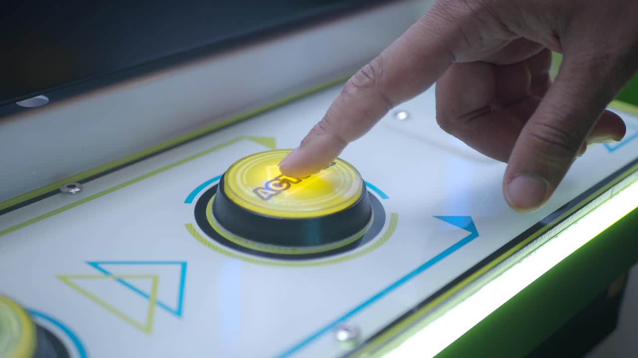 Person Pressing a Button on a Modern Arcade Machine