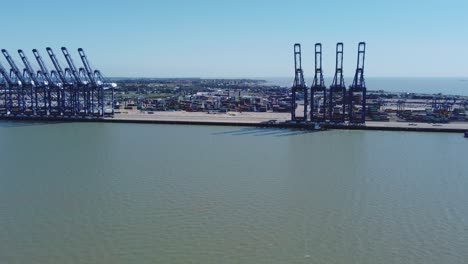 Cranes-and-containers-filmed-from-the-air-at-Felixstowe-harbour,-Hutchison-Ports,-Suffolk,-UK