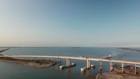 aerial approach of the bridge over the gulf intercoastal waterway shipping channel on jfk causeway at southern end of corpus christi bay in texas texas