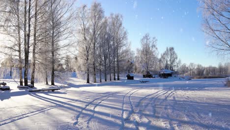 Frozen-lake-with-many-tracks-of-sledges-and-vehicles-in-rural-area,-bright-sunny-day