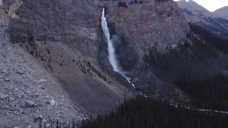 Waterfall-in-the-mountains-above-forest-mist-rising-shot