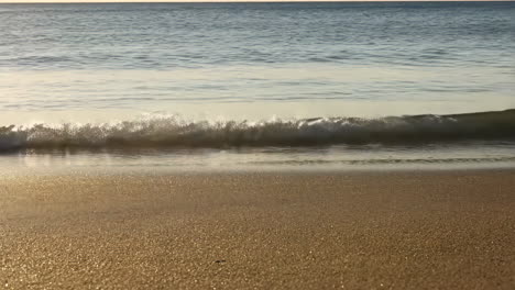 tranquil waves on a sandy beach at golden hour