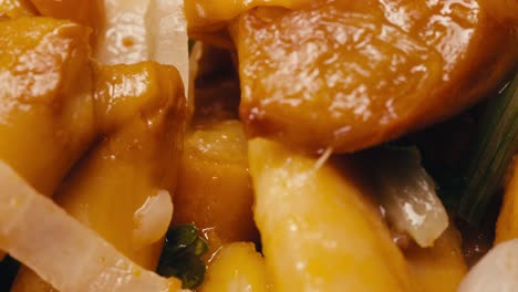 close-up of fermented yellow honeydew mushrooms with onion on plate. preservation of vegetables in glass jars. fermentation preserved mushroom with spices rotating macro.