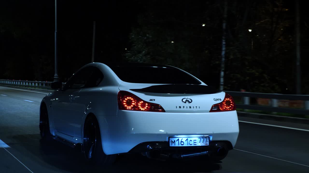 Infiniti Q60 on the road at night