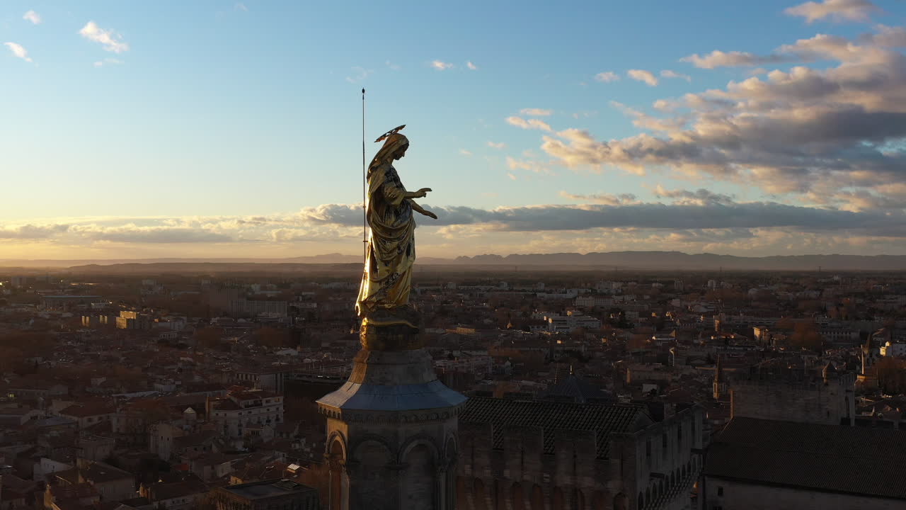 Golden virgin mary statue aerial shot Avignon Palais des Papes France sunrise