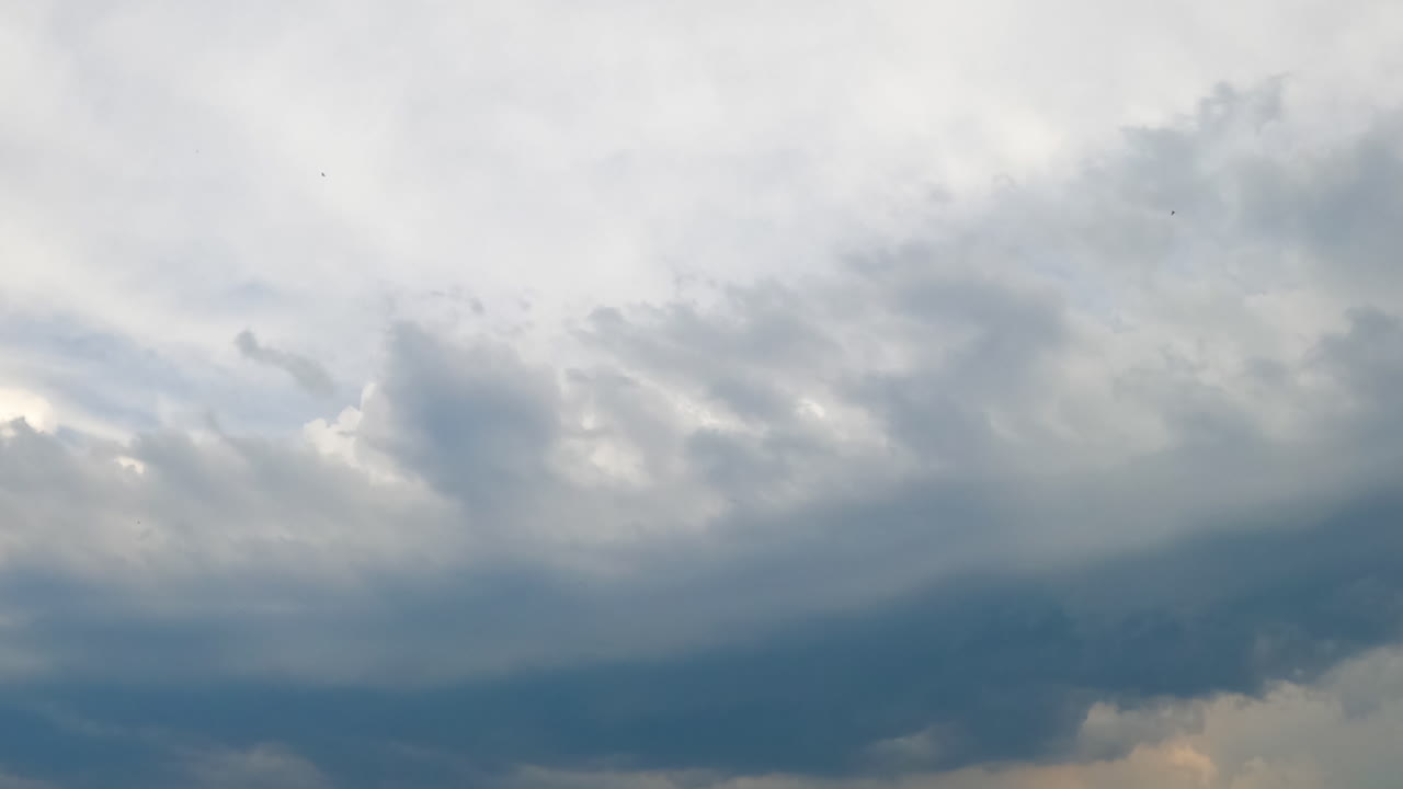 Combination of two diverse types of cloudscape in the atmosphere. Cumulus clouds rise up to the cirrus clouds. Timelapse.