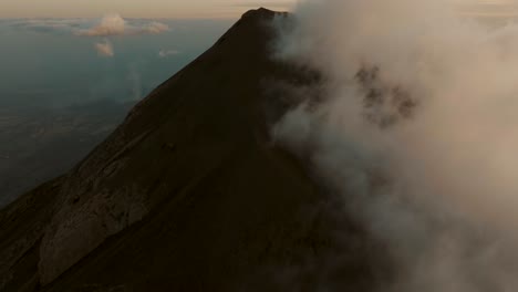 Fuego-volcano-during-sunset-in-Guatemala.-Aerial-tilt-up