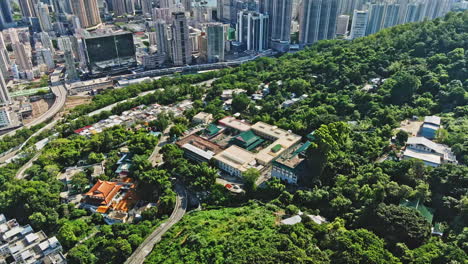 aerial drone shot of old temple in tsuen wan, hong kong cityscape