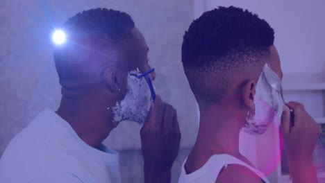 animation of lights over back of african american father and son shaving beards