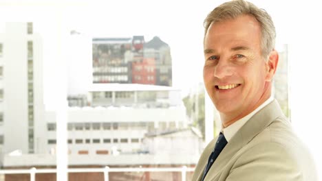 businessman turning to camera with arms crossed