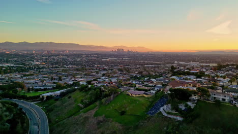 aerial drone viewpoint cityscape of los angeles la kenneth hanh sightseeing city town with mountain background and colorful golden hour skyline