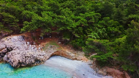 Small-bay-with-beach-at-wilderness-area-of-woodland-rocky-island-in-Marmaris