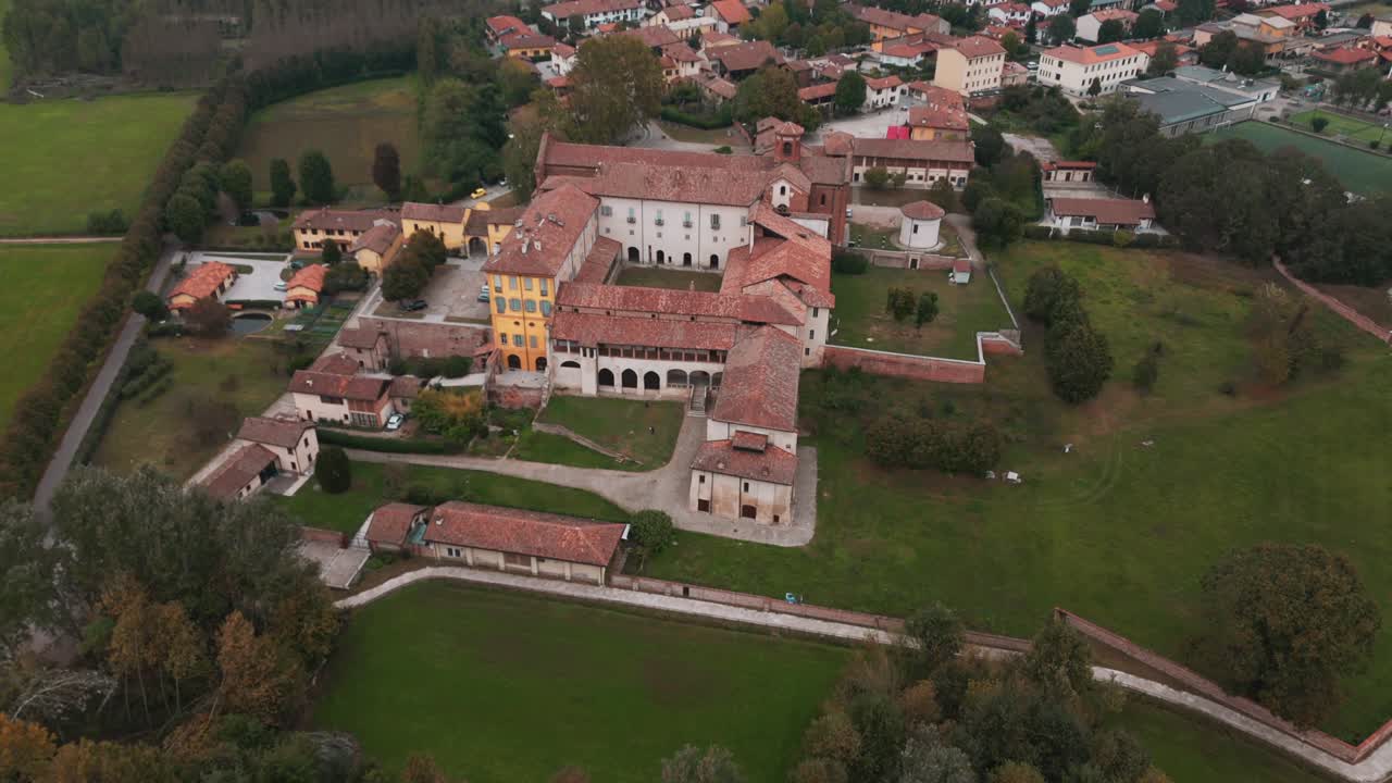 Tilting movement Abbazia Morimondo top shot in the countryside of Lombardia close to Abbiategrasso
