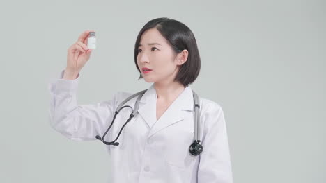 medical vaccine or hand with doctor woman holding bottle of medication in a hospital