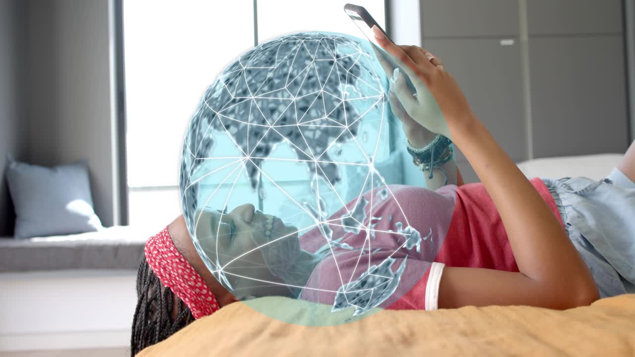 Woman reclining on bed tapping smartphone summoning rotating AR globe over torso showing tech links
