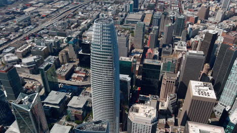 Aerial-view-looking-down-at-Salesforce-skyscraper-tower,-San-Francisco-cityscape-landmark