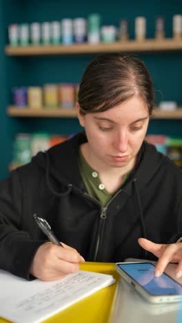 woman studying and taking notes