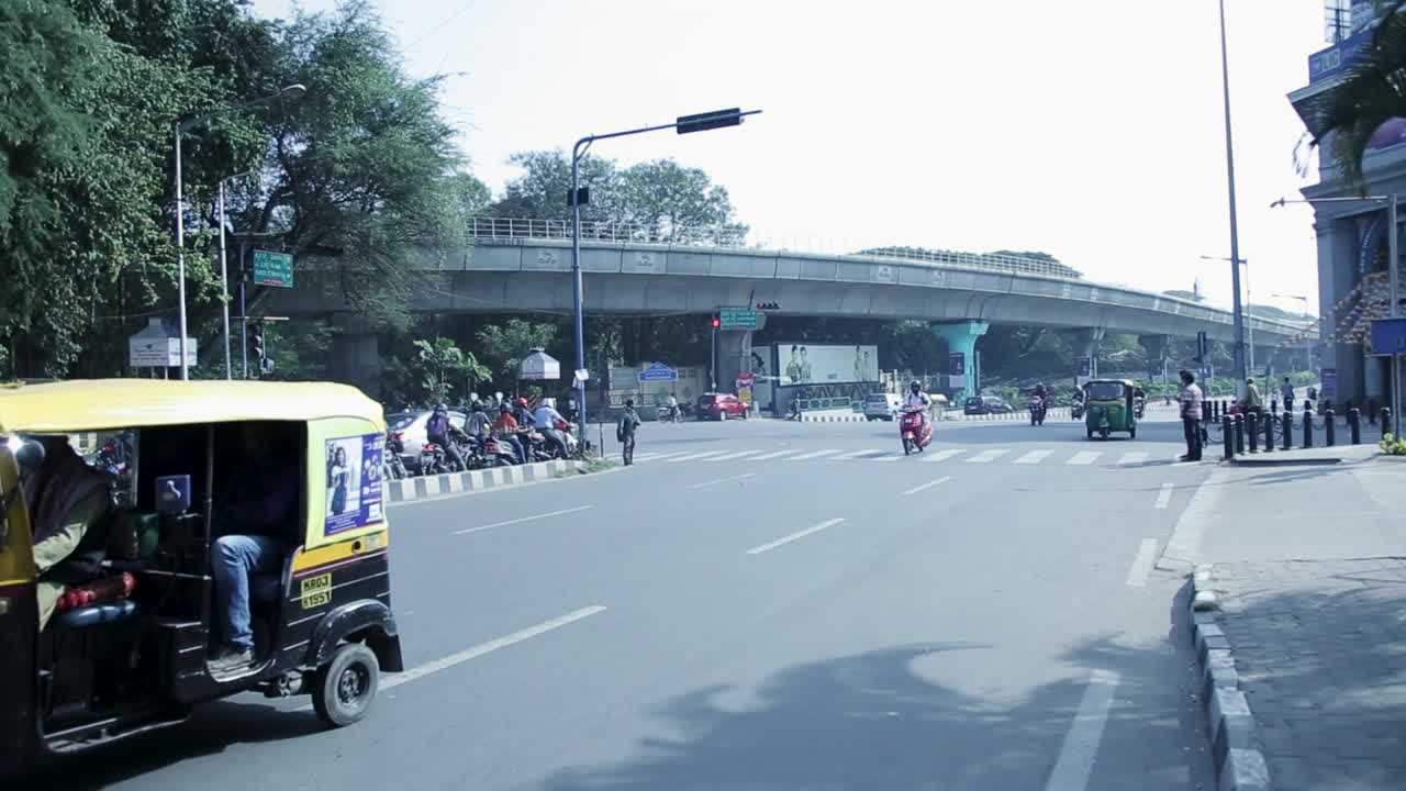 Busy City Street Scene in India with Elevated Train