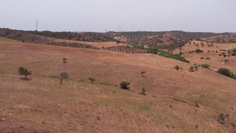 Flying-Over-The-Vast-Slope-Landscape-In-Alentejo,-Portugal