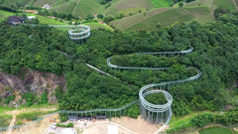 backward drone view of longest glass water slide in lujia village, zhejiang province, china