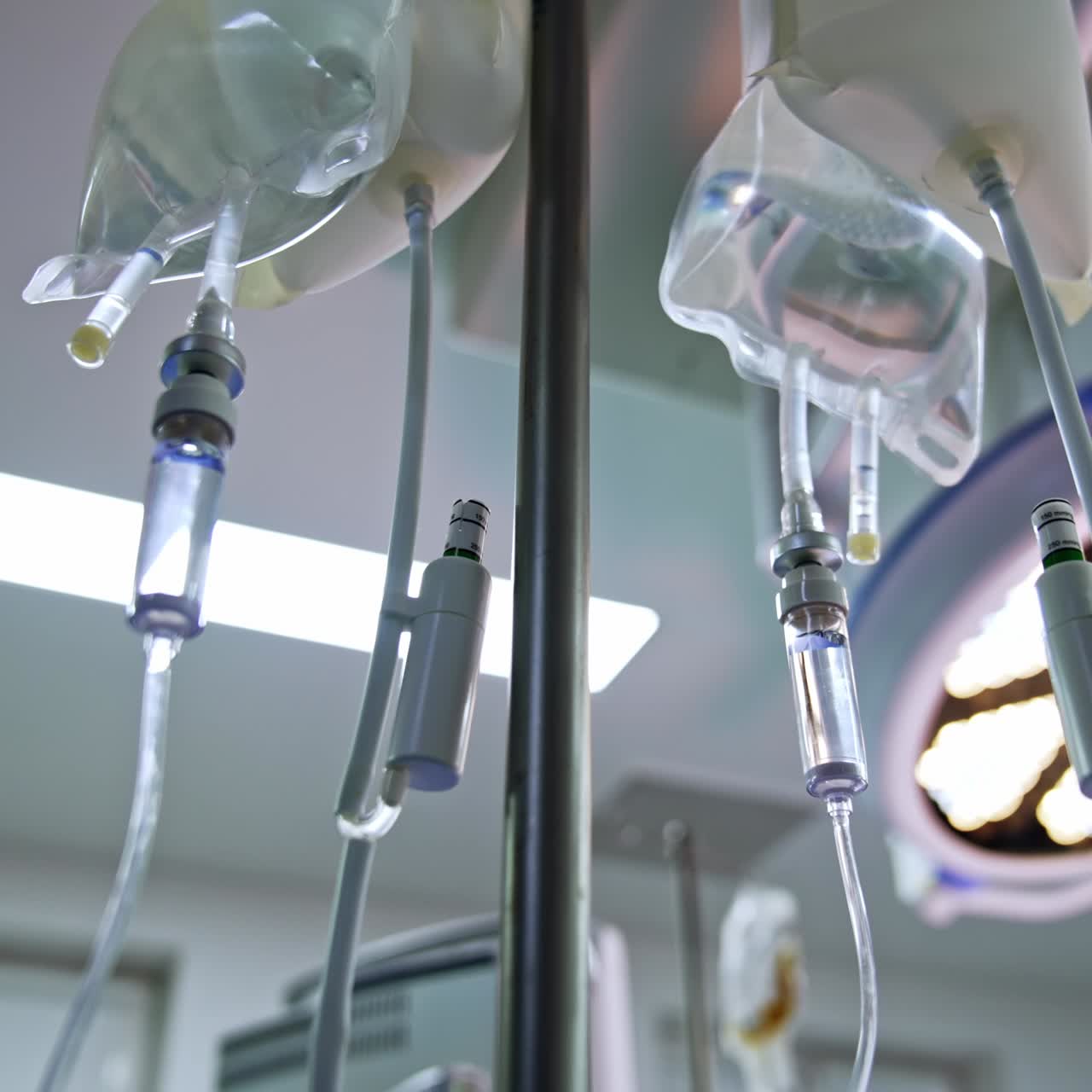 Drop counters hanging in the surgical room. Illumination equipment at backdrop. Low angle view