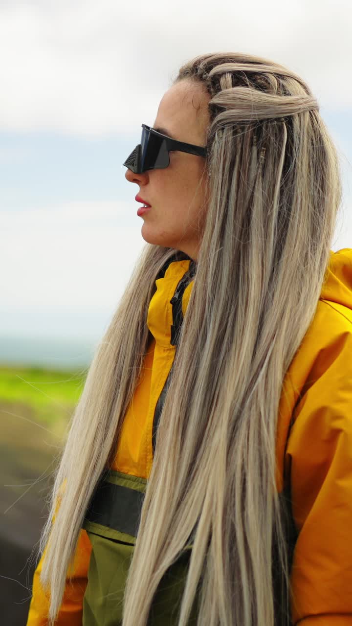 Young Woman in Yellow Jacket and Sunglasses Looking at Nature