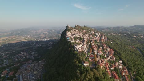 San-Marino,-Italy,-city-on-a-mountain,-city-building,-drone-orbit-view