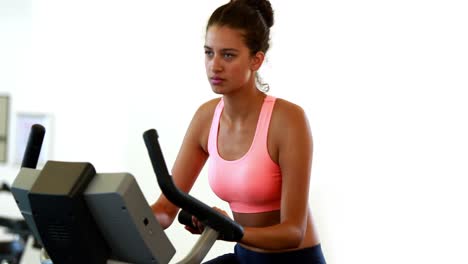 Fit-brunette-working-out-on-the-exercise-bike