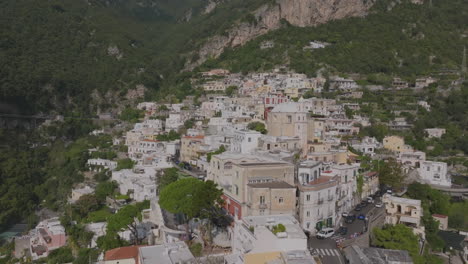 aerial footage of the buildings on the hills above positano flying towards a church