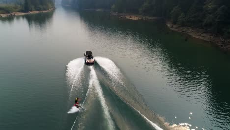 man wakeboarding with motorboat in the river 4k