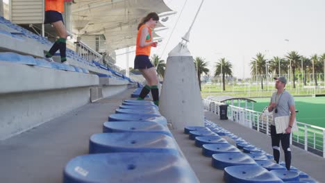 Female-hockey-players-warming-up-in-stands