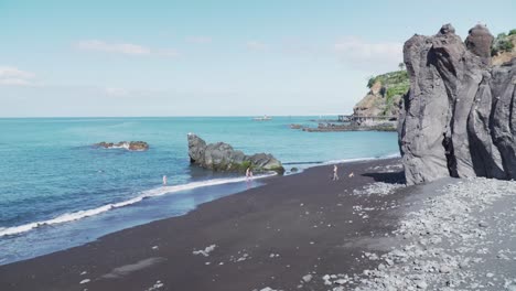 black sand beach with people