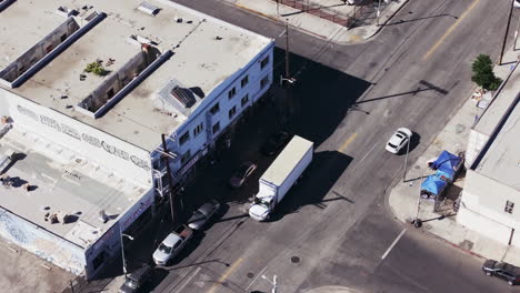 aerial view of an urban street with buildings and vehicles