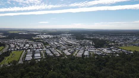 aerial view of a modern suburban residential development surrounded by forest