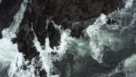 Orbiting-Over-Rocky-Seafront-With-Splashing-Waves
