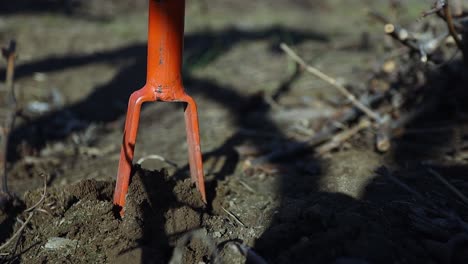 close up head of hand auger as it is twisted, digging a hole in soil