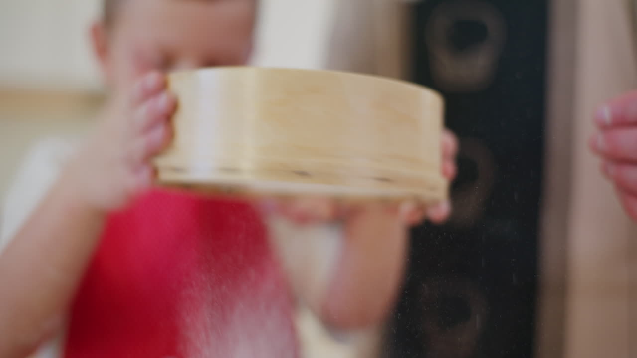 Boy Sifting Flour And Helping Dad With Baking In The Kitchen