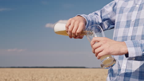 man pours beer from a bottle into a glass 1