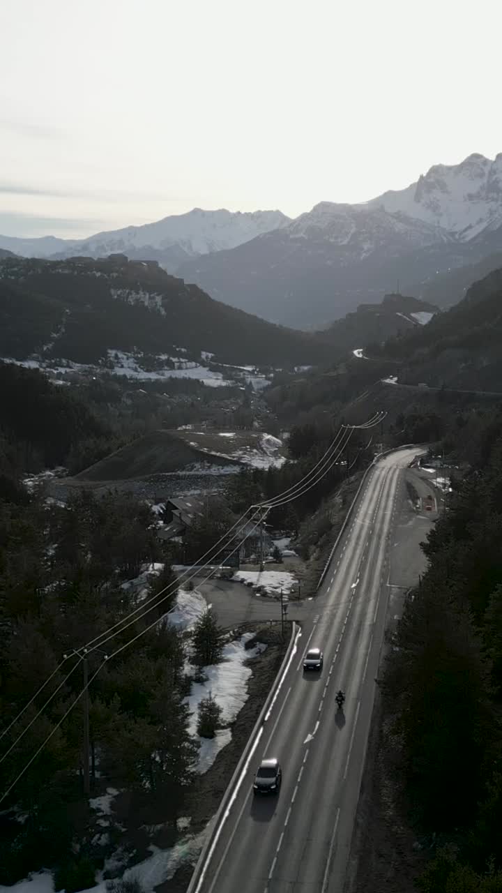 Mountain road with snow and cars
