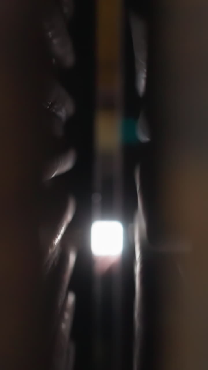 Metal details of heating radiators with pipes in building boiler house closeup. Equipment for mechanical room in plant warehouse against glowing lamp