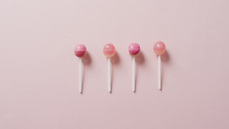 video of pink lollipops on pink background