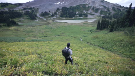 tourist photographer admiring the beautiful landscape by garibaldi lake in canada