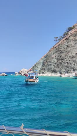 a boat is sailing in the ocean near a rocky shore