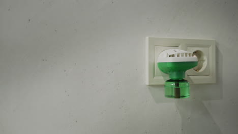 electric fumigator in an electrical outlet on the wall