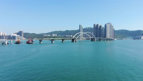 Hong-Kong-cross-bay-link-construction-project,-a-dual-two-lane-bridge-connecting-Tseung-Kwan-O-Lam-Tin-Tunnel-to-Wan-Po-Road,-Aerial-view