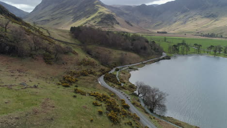 aerial drone shot of buttermere lake panning up to reveal fleetwith pike fell lake district cumbria united kingdom