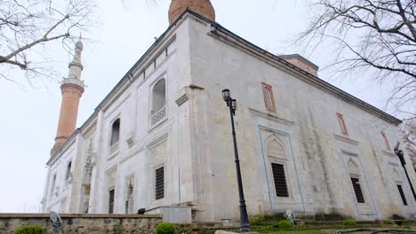 bursa turkey. green mosque (yesil camii) with its minaret extends to cloudy sky