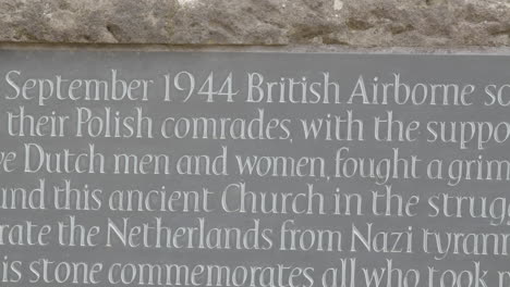 medium pan over world war 2 memorial stone at the old church in oosterbeek, the netherlands