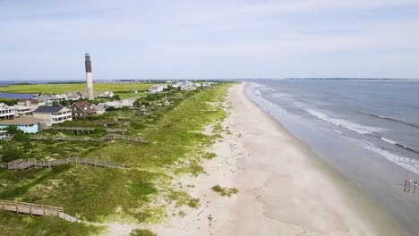 oak island lighthouse on a bright sunny day with empty beach