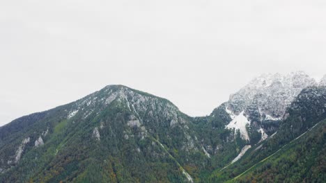 Aerial-panning-shot-of-rolling-hills,-white-peaks,-Alps-,Zell,-Austria